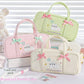 Three cute pencil bags with cute cat designs and pink bows on a white background.