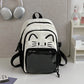 Black neko backpack displayed by a white wall