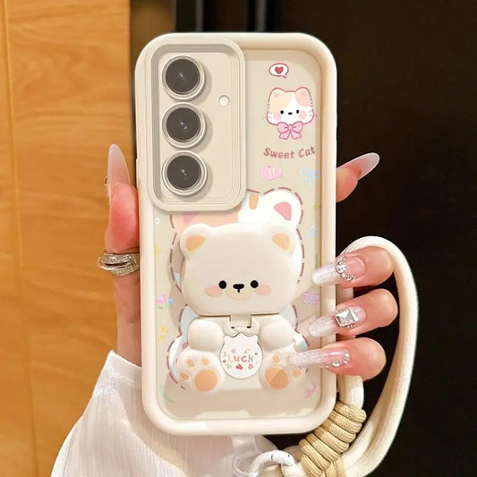 A woman is holding the Kawaii Cuties Samsung Phone Case, showing a closer view of the design of the case which features a sweet cat and a bear as a phone stand, which also includes the mirror when you position its head a certain way.