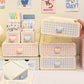 Set of cute stationery items including pens, markers, and a small box with checkered design.
