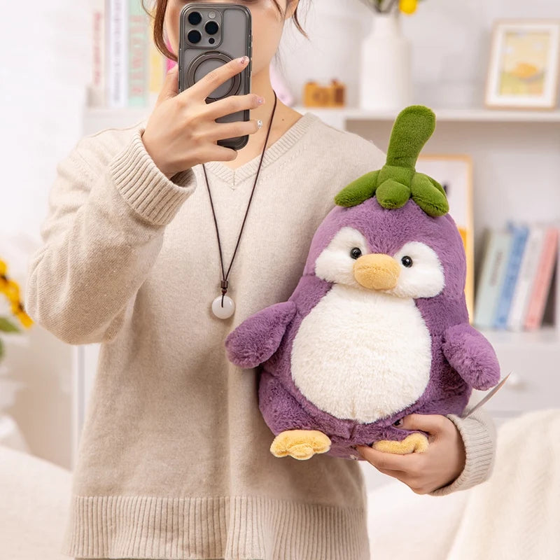 Front view of Kawaii Cute Penguin Eggplant Plushie being held by a woman