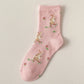 Pink sock with bunny pattern on a beige background
