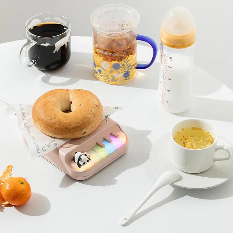 Kawaii Panda Piano Cup Heater with various food elements around it 