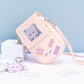 Pink game console-themed crossbody bag with a light blue background