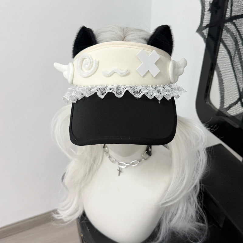 Black visor cap with white accents and decorative elements on a mannequin head with white hair.