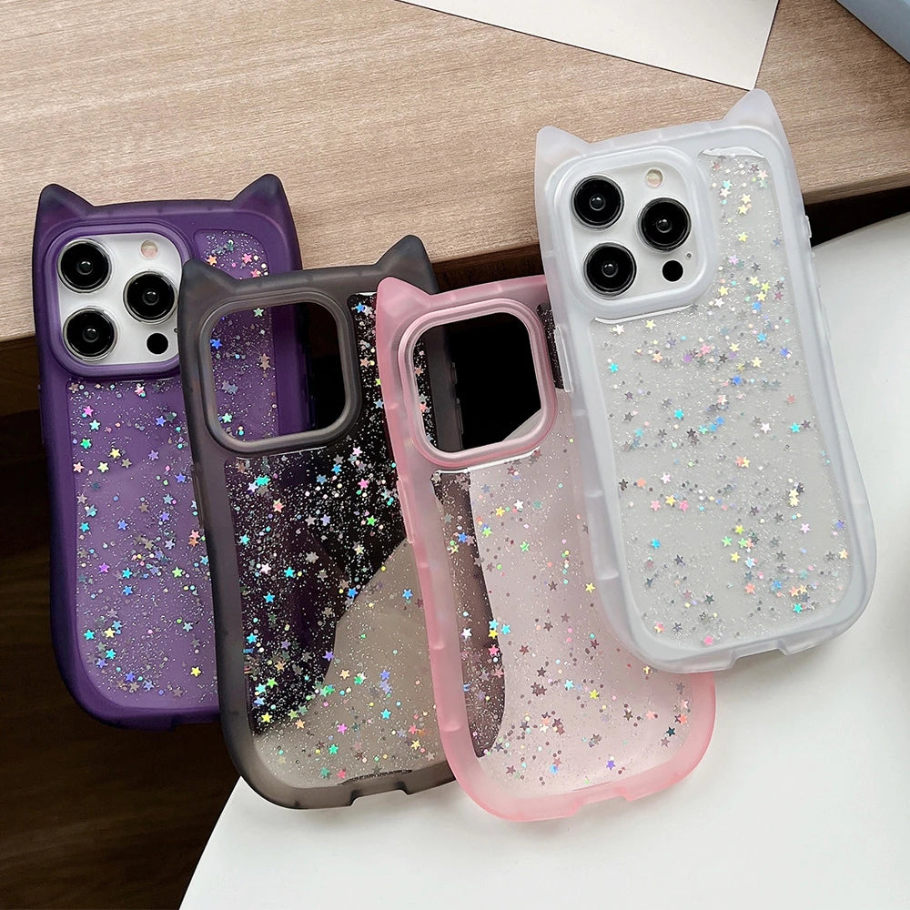Four glittery phone cases in different colors on a wooden surface.