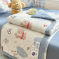 Kawaii Spring Quilts , the set being shown is the Cute Brown Dog Design with Blue, its shown half open on a bed.