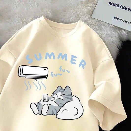 Beige t shirt with a cartoon design of a cat and air conditioner on a textured surface.