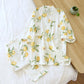 White outfit with lemon print on a wooden surface