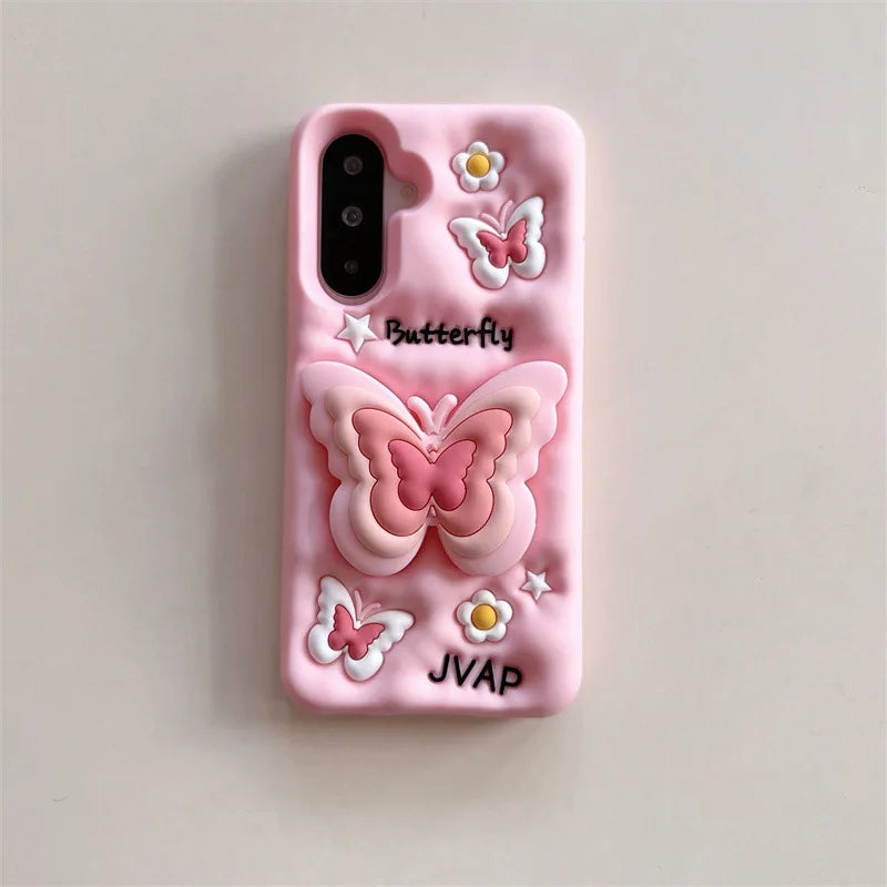 This image is showing  Kawaii Butterfly Samsung Phone Case, one option is the pink design with a large 3D butterfly in the middle which is a phone grip with smaller butterflies around it and some white flowers.