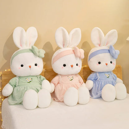 Miss Usagi Plushies, placed on a bed displaying the three different different designs you can buy, from white and pink to white and blue and even white and green!