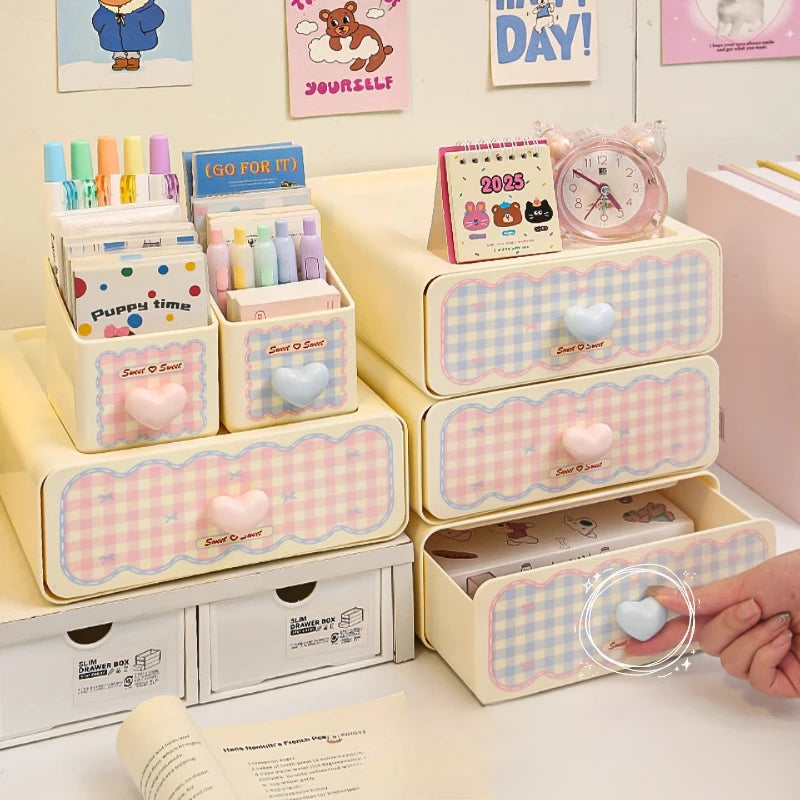 Pastel-colored desk organizer with drawers and stationery items on a desk.