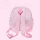Pink backpack with straps on a polka dot background