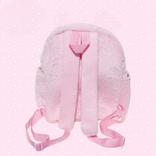Pink backpack with straps on a polka dot background