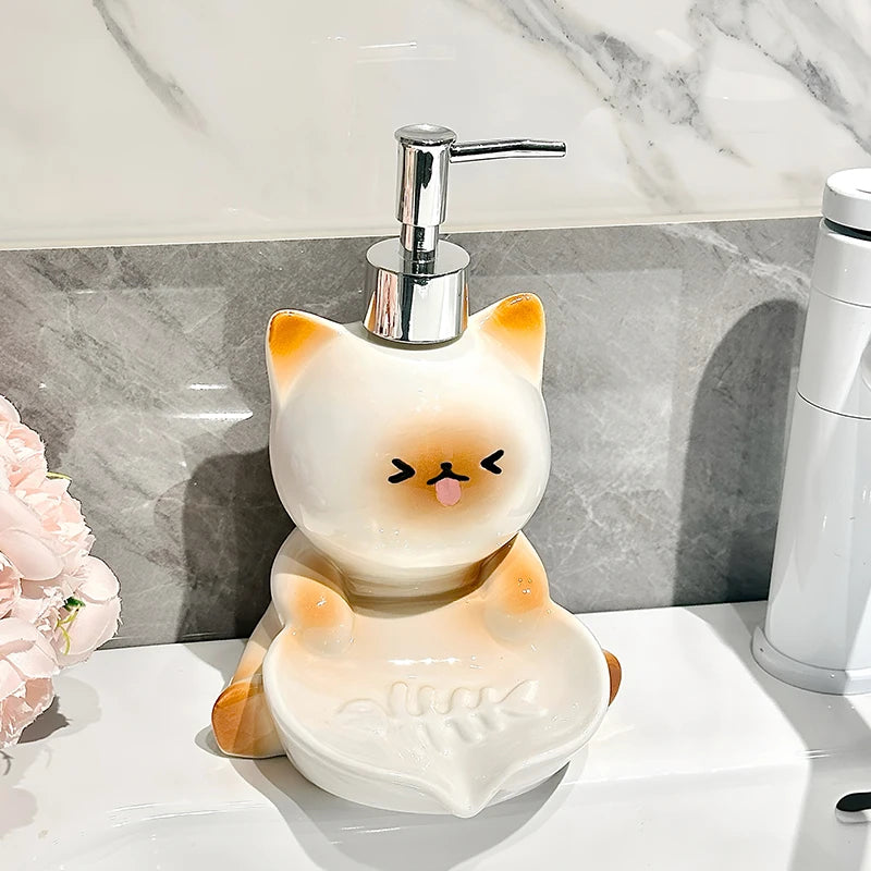 Cat-shaped soap dispenser on a marble countertop with a floral arrangement.