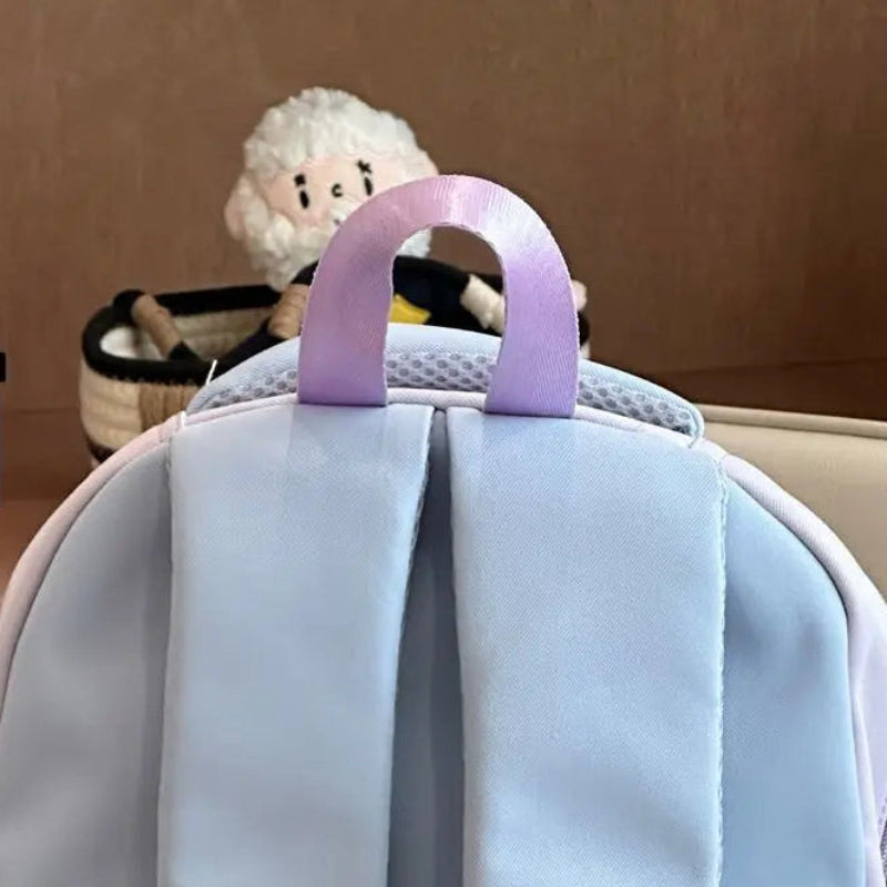 Beary cute backpack handle and straps close up with a plushie in the background.