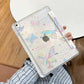 Person holding the ipad case with a colorful butterflies on a wooden background