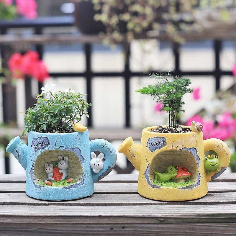 Two decorative teapots with plants inside, one blue and one yellow, on a wooden surface.