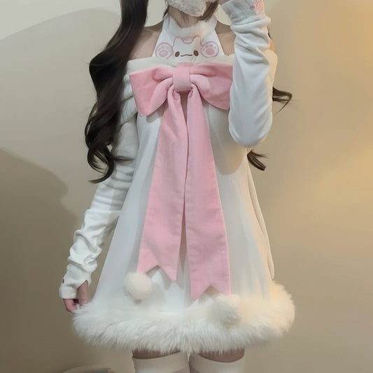 Person wearing a white outfit with a large pink bow and fluffy details