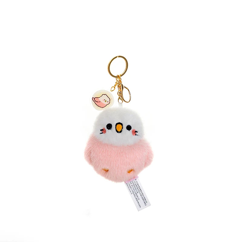 kawaii pink and white bird plushie keychain on a white background