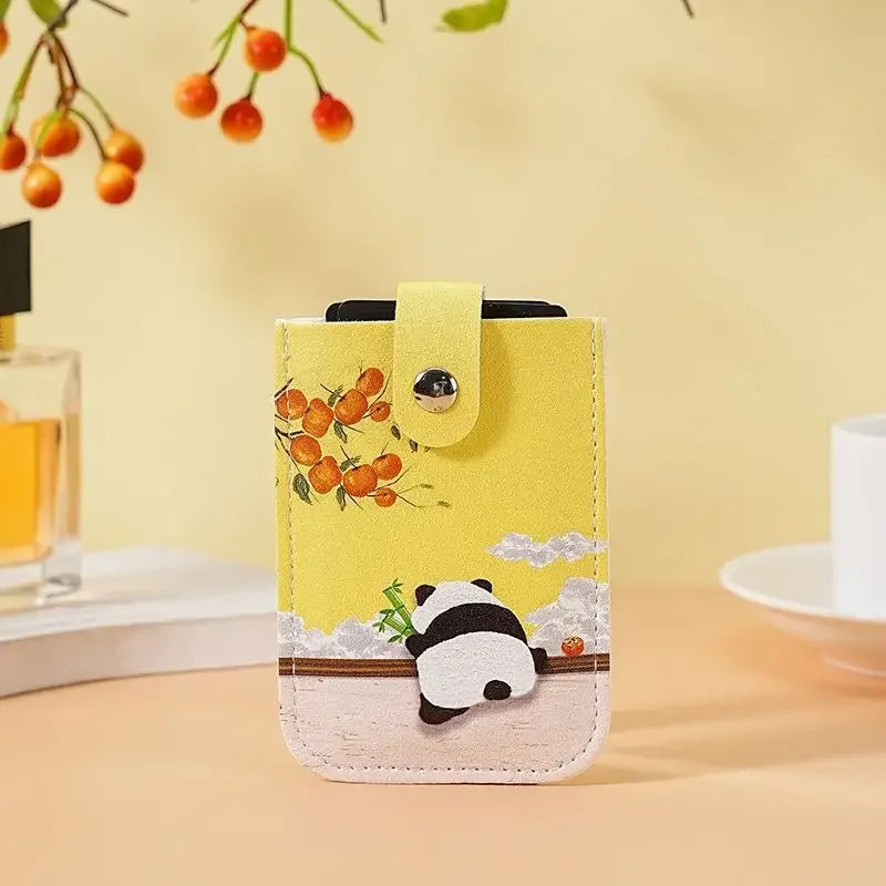Yellow phone case with panda design on a blurred background