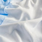 Close-up of light blue and white fabric with folds