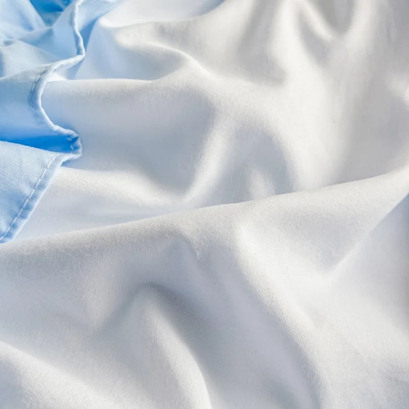 Close-up of light blue and white fabric with folds