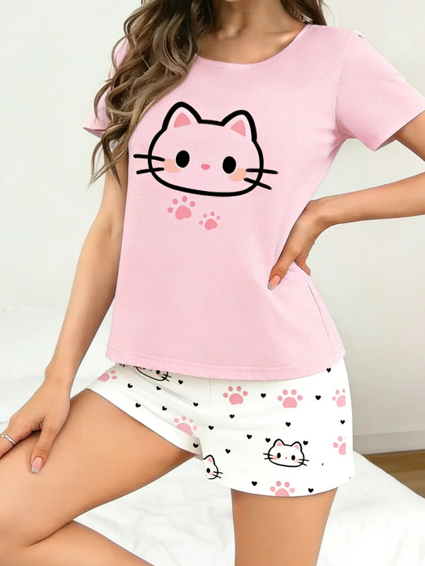 Person wearing a pink t-shirt with a kawaii cat face design and white shorts with cat face and paw prints on a plain background.
