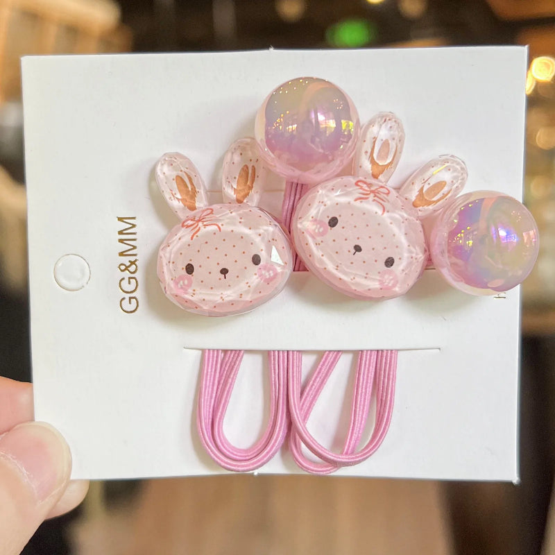 Pink bunny-shaped hair clips on a white card with 'GG&MM' branding.