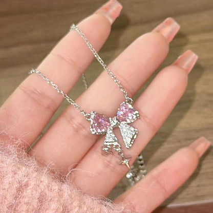 Model Holding Kawaii Pink Bow Pendant Necklace