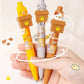 Kawaii Peek-a-Boo Cat Pens, positioned in front of a white background, with a hand holding them.