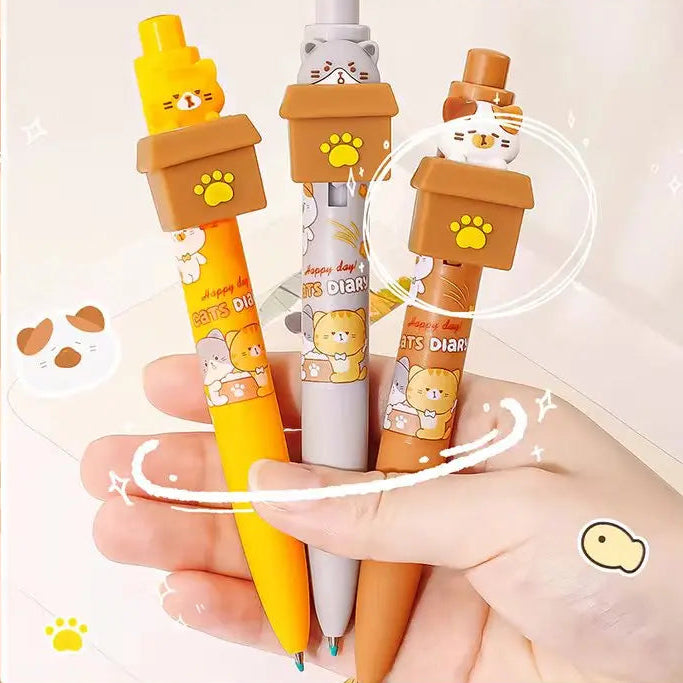 Kawaii Peek-a-Boo Cat Pens, positioned in front of a white background, with a hand holding them.