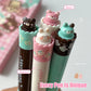 Set of four cute pens with animal-themed caps on a light background