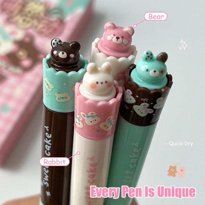 Set of four cute pens with animal-themed caps on a light background