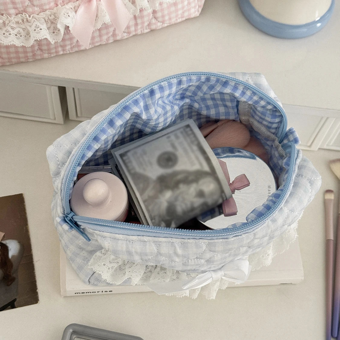 Blue checkered pencil case with personal items on a desk