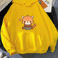 Yellow hoodie with a red panda design on a surface