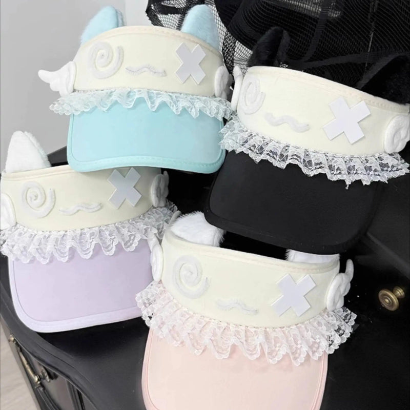 Set of pastel-colored baby shoes with lace details on a black surface.