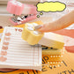 Kawaii Pastel Cat Paw Stapler, this image is showing the Yellow option of the stapler in use on a cute note book.