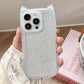 Clear phone case with star patterns held by a hand, with a blurred background