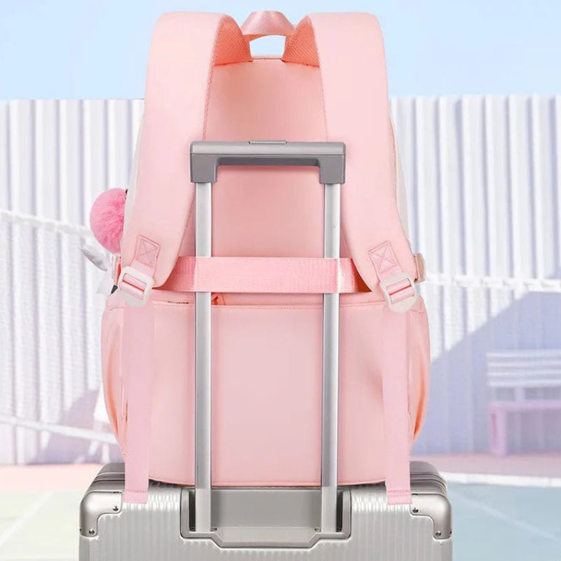 Pink luggage trolley strap attached to a suitcase with a light blue background