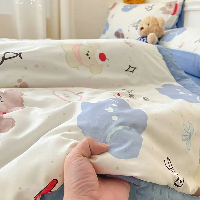 Children's bed with cartoon bedding and a teddy bear in the background