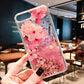 Phone case with pink sakura design held in a hand, indoor setting