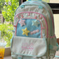 Kawaii backpack with star designs on a table near a window