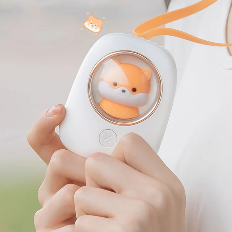 Hand holding a white device with a kawaii shiba inu face.