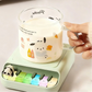 Green Kawaii Panda Piano Cup Heater held by a woman on a table
