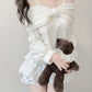 Kawaii White Sweet Off Shoulder Sweater worn by a woman holding a teddy bear 