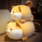 Two stacked shiba inu plushies on a chair.