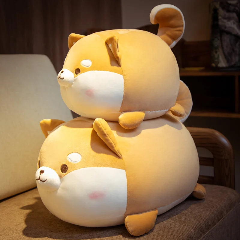 Two stacked shiba inu plushies on a chair.