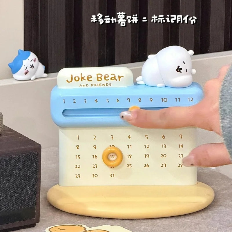 Calendar with a bear design and 'Joke Bear' branding, held by a hand.