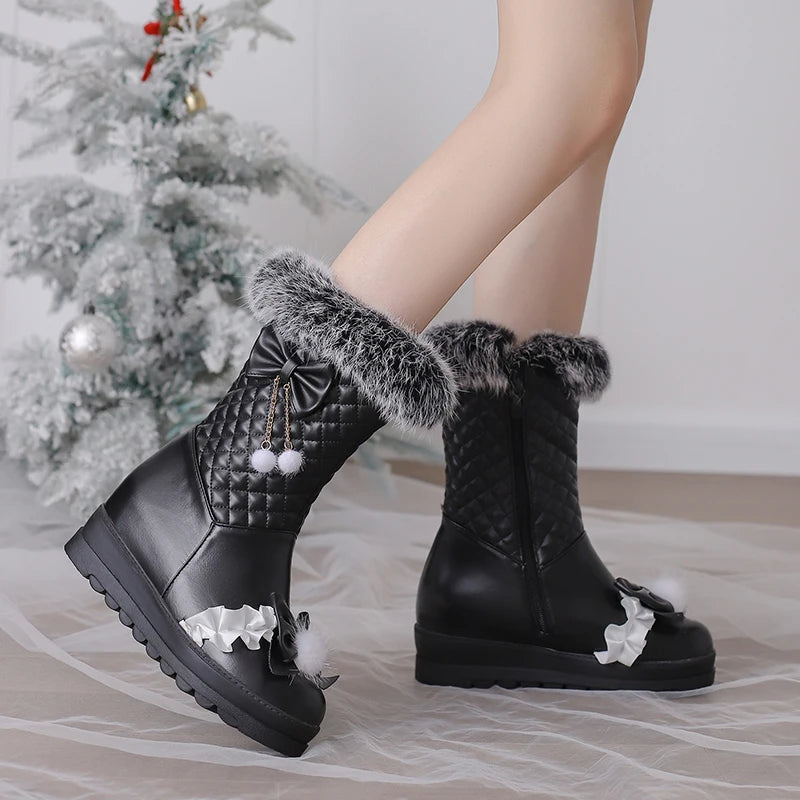 Black quilted boots with fur trim and decorative elements on a neutral background